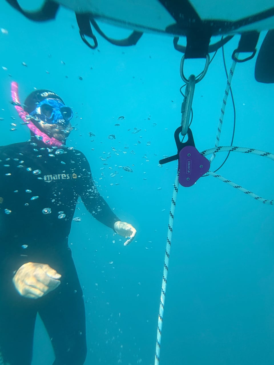 Freitaucher am Seil unter einer Boje
